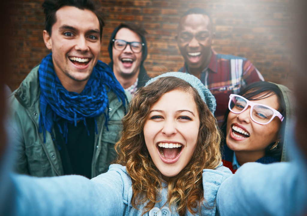 A group of youth smiling with beautiful teeth