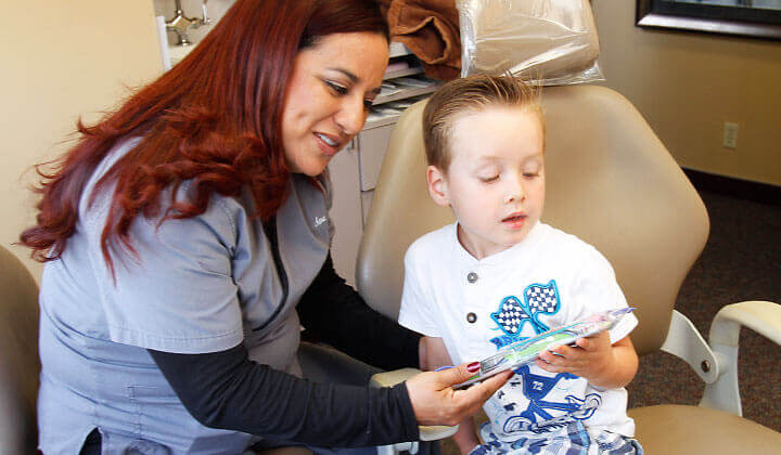 A child receiving a toothbrush after treatment
