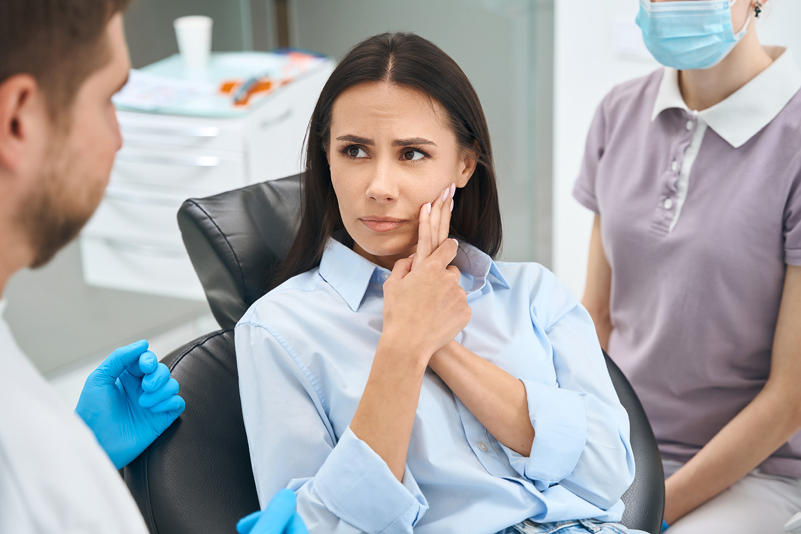 A woman with a toothache visiting the dentist