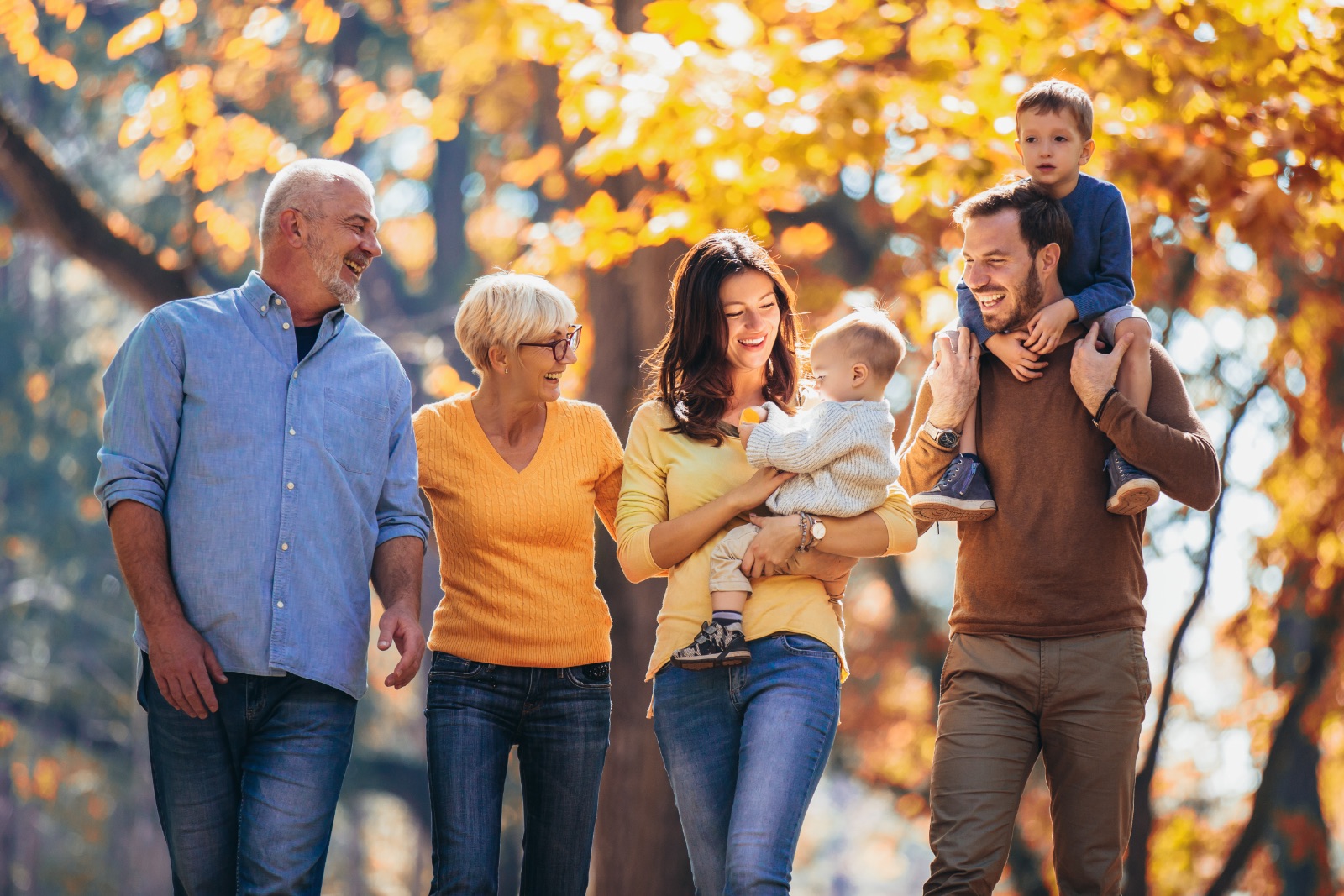 Multl generation family in autumn park having fun